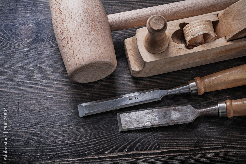 Wooden mallet flat chisels planer on wood board