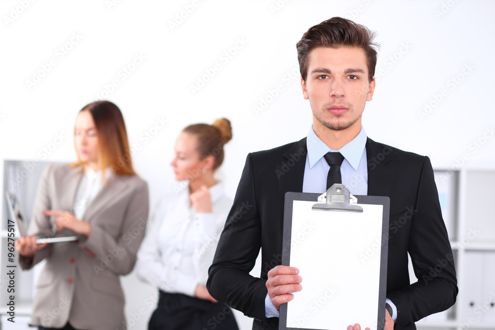 Unknown businessman holds clipboard with copy space area