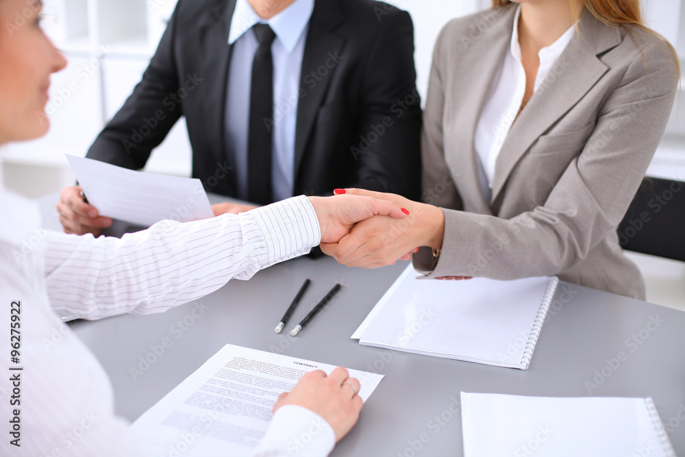 Business people shaking hands, finishing up a meeting. Copy space at the left corner Business people shaking hands, finishing up a meeting. Copy space at the left corner