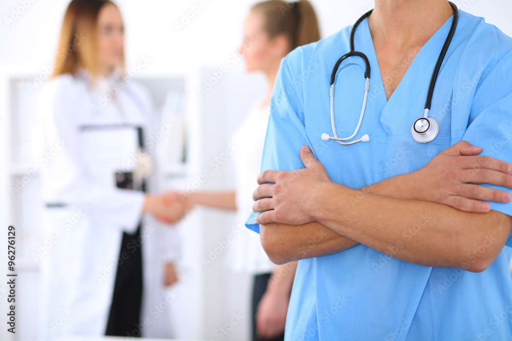 Unknown male surgeon doctor with stethoscope, crossed arms Unknown male surgeon doctor with stethoscope, crossed arms
