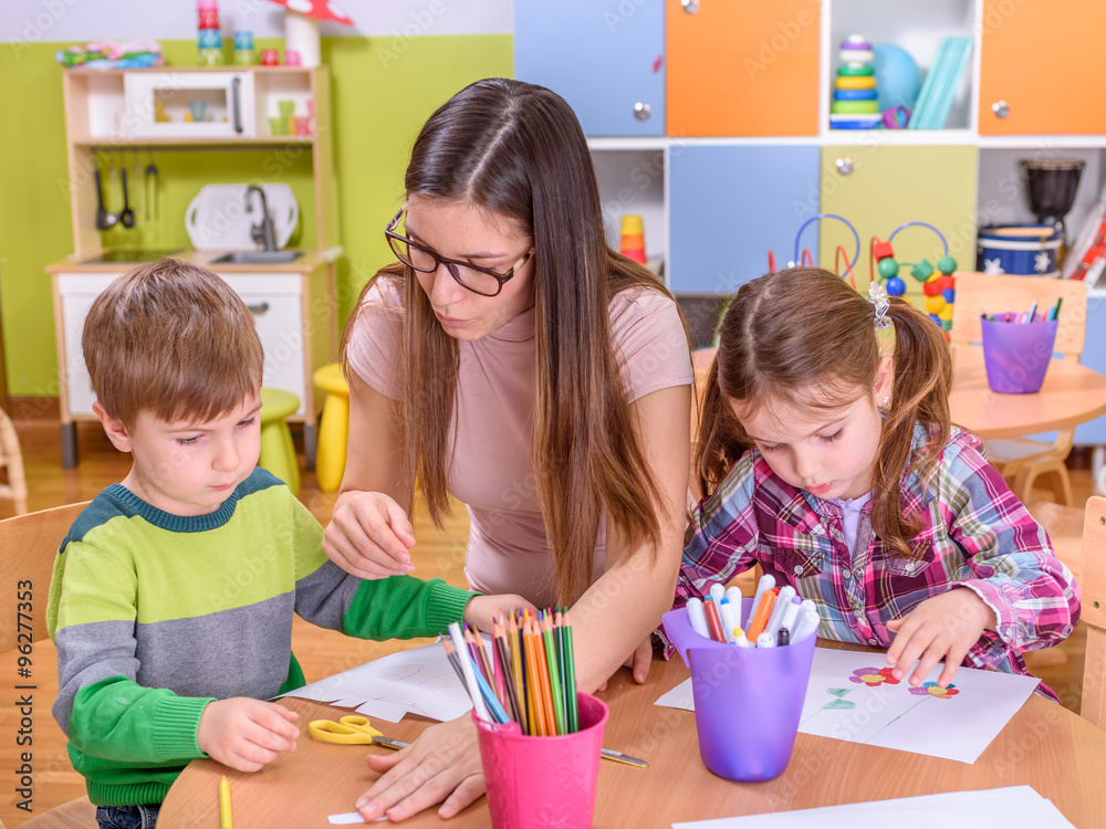 Naklejka premium Preschool Kids Drawing With Teacher