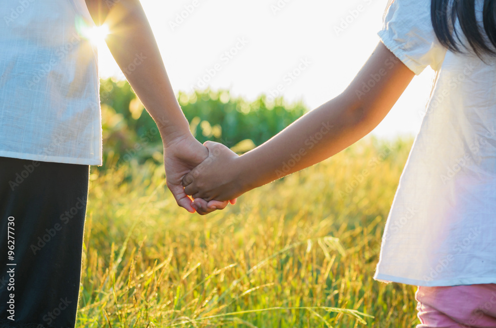 elder sister and younger sister holds the hand and sunset elder sister and younger sister holds the hand and sunset