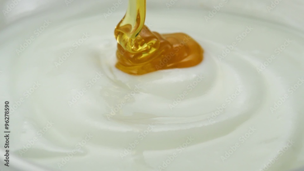 Honey pouring on yogurt shooting with high speed camera. Honey pouring on yogurt shooting with high speed camera.