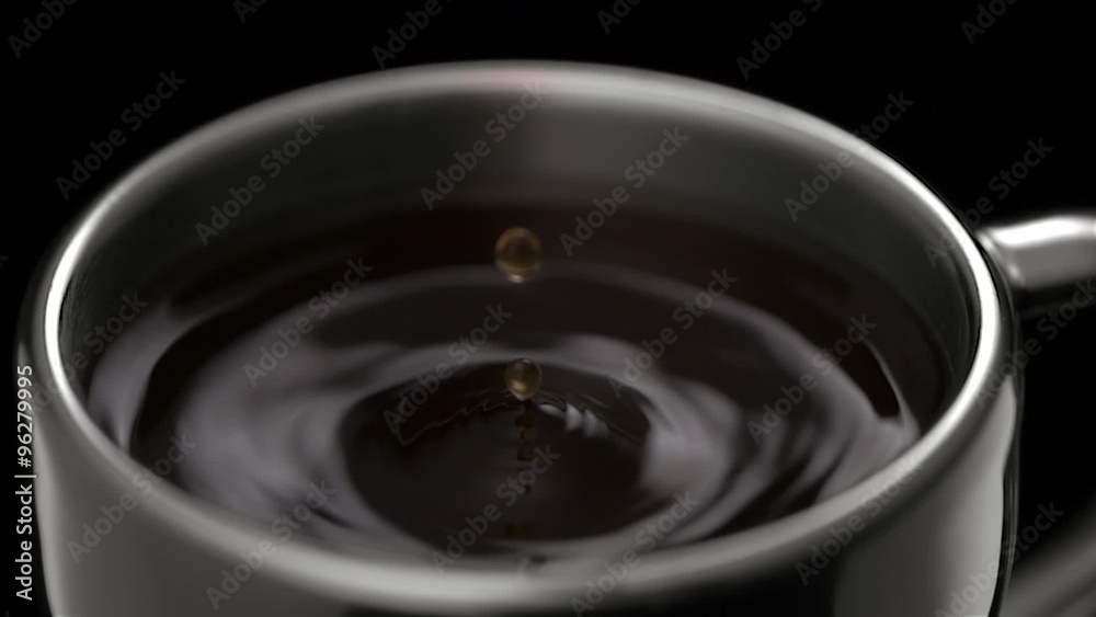 Coffee drop making ripple in cup shooting with high speed camera.
