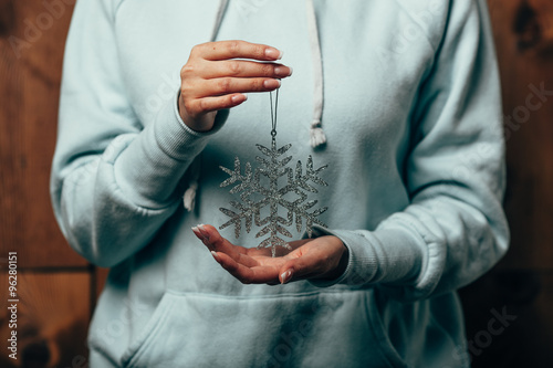 woman hands holding snowflake toy