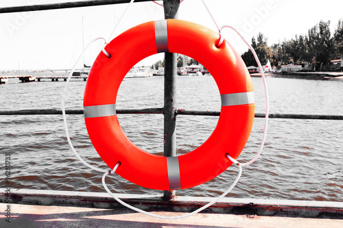 A life buoy hangs on the pier's handrail