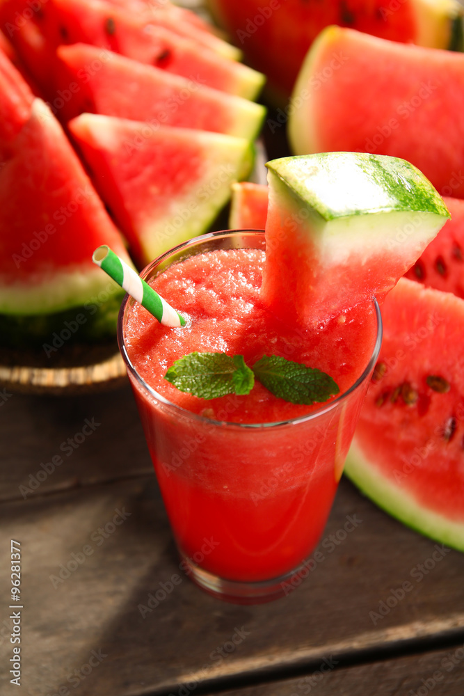 Glass of watermelon juice on wooden table, closeup Glass of watermelon juice on wooden table, closeup