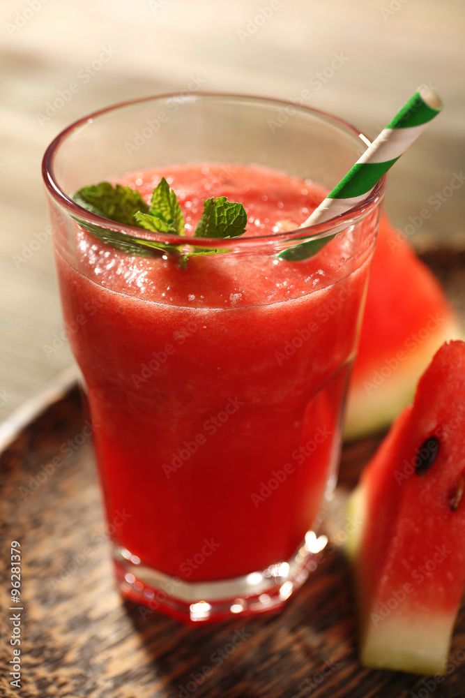 Glass of watermelon juice on wooden table, closeup Glass of watermelon juice on wooden table, closeup
