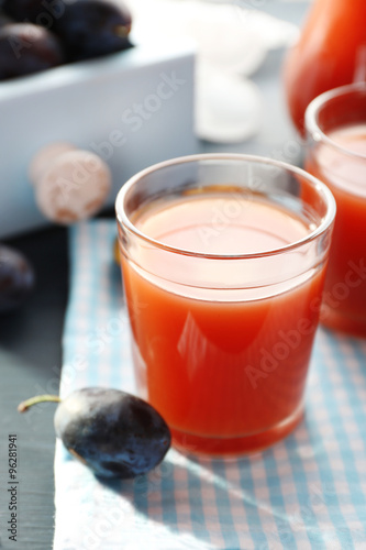 Plum Juice in a glasses with fresh fruits