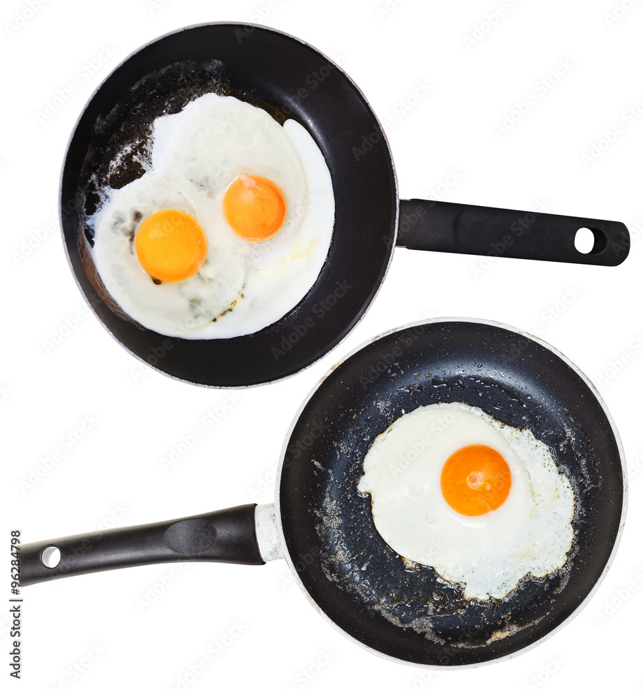 frypans with one and two fried eggs isolated frypans with one and two fried eggs isolated