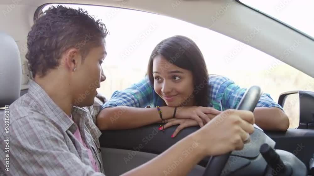 Hispanic couple talking to each other in the car Hispanic couple talking to each other in the car