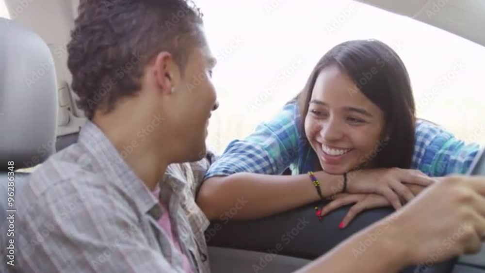 Sweet Hispanic couple talking to each other in the car Sweet Hispanic couple talking to each other in the car