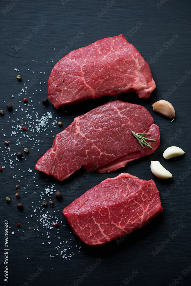 Close-up of raw fresh black angus beef with seasonings, top view