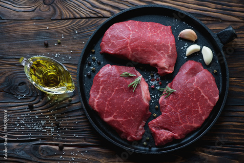 Photography Top view of raw fresh black angus beef steaks in a frying pan
