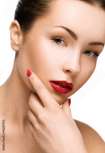 Beautiful young model with red lips and red manicure on white ba