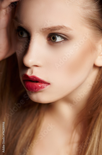 Blond female with bright make up.