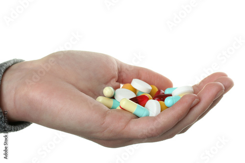 the woman in the sweater keeps in the hand of pills on white background