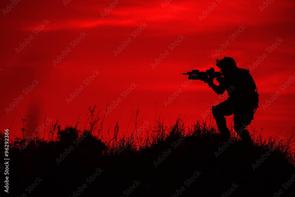 Fototapeta premium Silhouette of soldier with rifle..