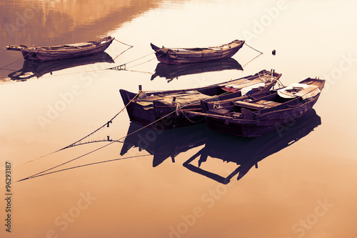 Traditional Chinese fishing boats out of wood. Image retro vintage filter effect.   