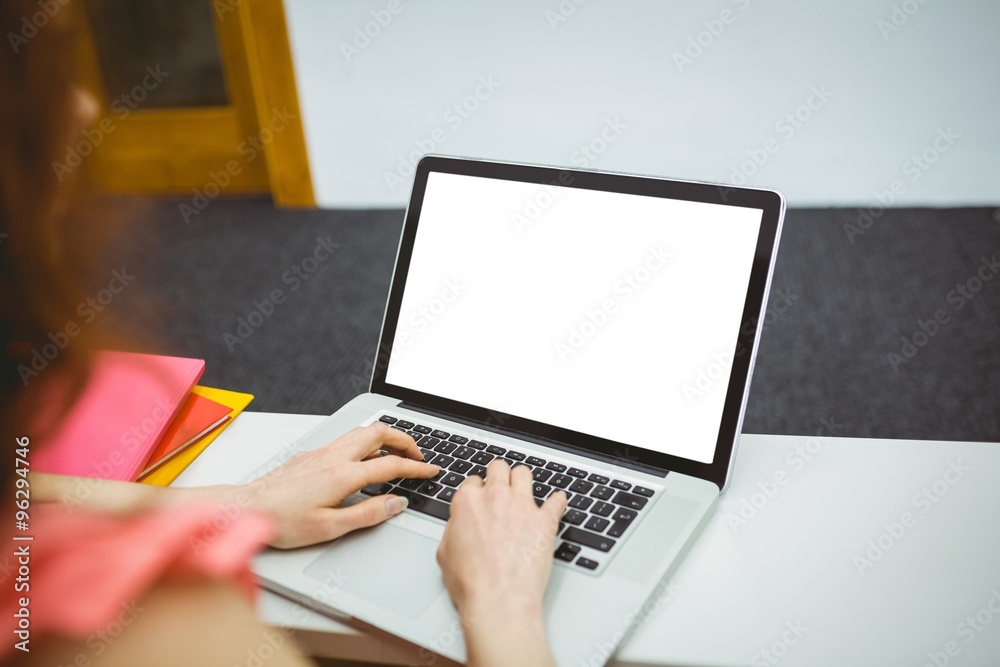Mature student in lecture hall using laptop Mature student in lecture hall using laptop