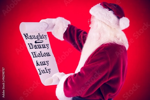 Composite image of santa claus reads a list photo