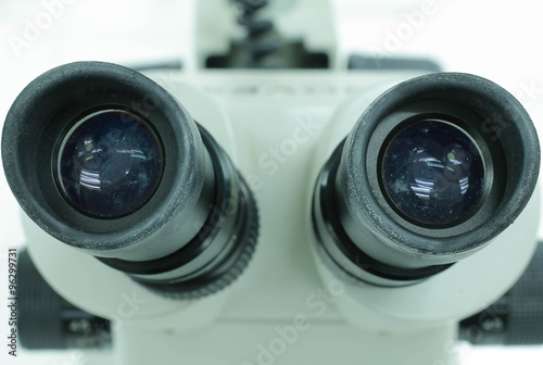 Close up of microscope lenses focused on a specimen