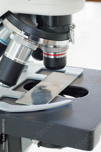 Close up of microscope lenses focused on a specimen