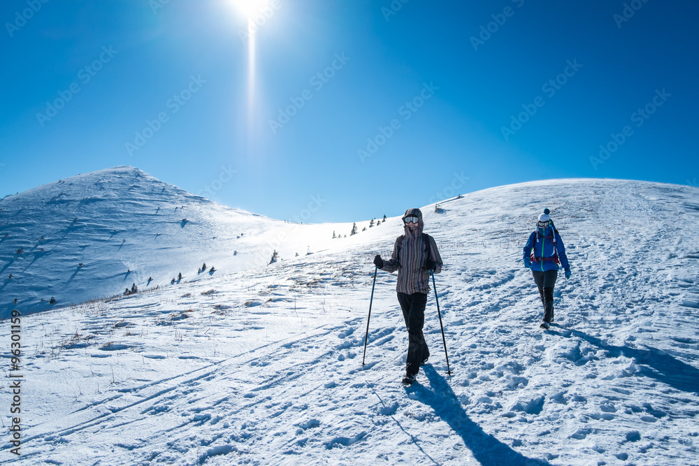Two women on a trip in the snowy Alps