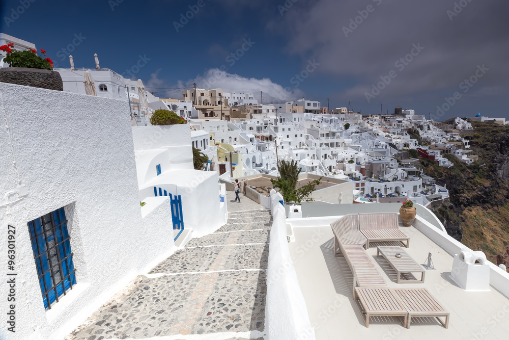 Fototapeta premium View of Oia traditional white houses and old castle of Oia, Sant