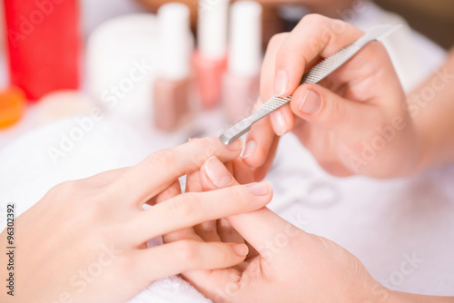 Professional manicurist  making manicure 