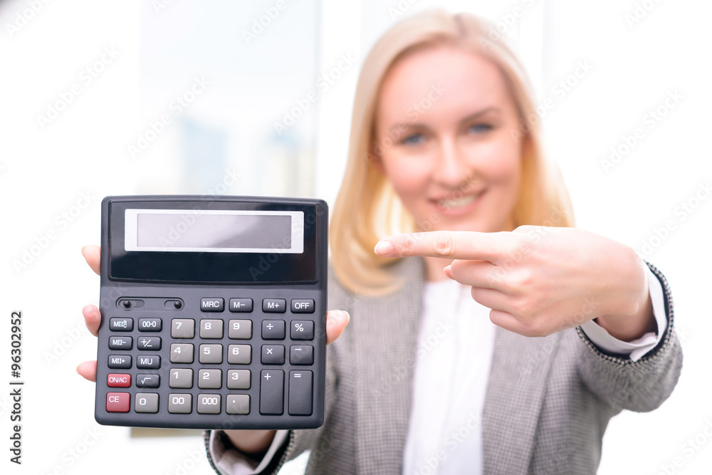 Pleasant businesswoman holding calculator Pleasant businesswoman holding calculator