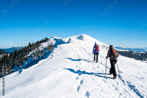 Girls go on snowy mountain peak © marvlc