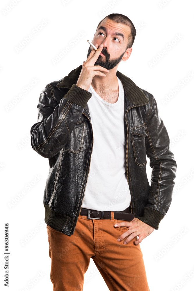 Fototapeta premium Man wearing a leather jacket smoking