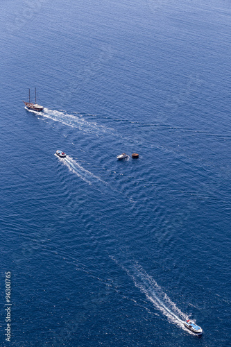 Yacht navigates into beautiful blue water near Santorini island, © ververidis