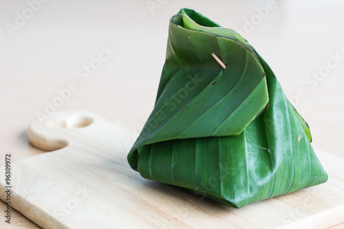 banana leaf, a natural food container on the light wood board