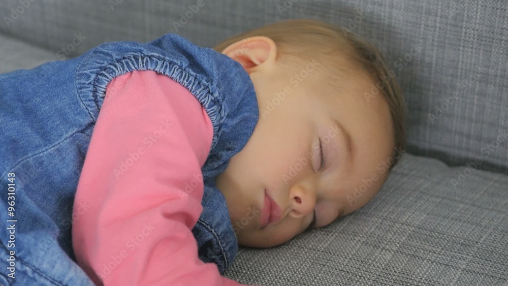 Baby girl taking a nap on couch Stock Video Adobe Stock