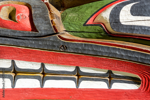 Close up detailing of an Native American carved ancient wooden colorful Totem pole in Victoria at Thunderbird Park, British Columbia, Canada.