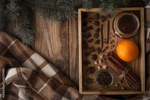 Orange , honey and spices on the wooden tray with plaid horizontal