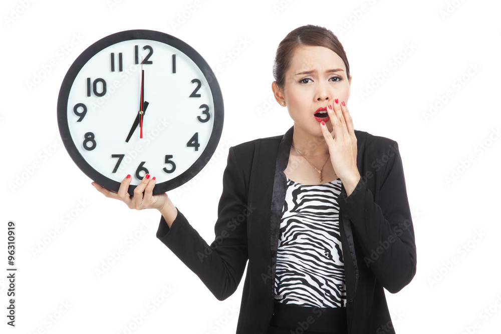 Sleepy young Asian business woman with a clock in the morning Sleepy young Asian business woman with a clock in the morning