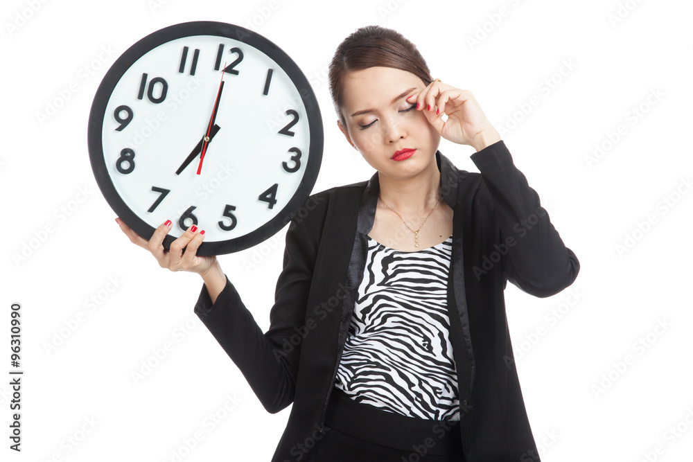 Sleepy young Asian business woman with a clock in the morning Sleepy young Asian business woman with a clock in the morning