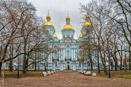 St. Nicholas Naval Cathedral on the background. The St.Nicholas garden with the banches by the cathedral entrance is on the foreground. photo