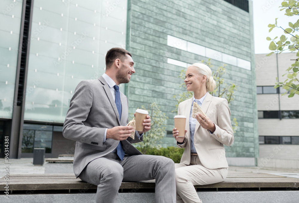 smiling businessmen with paper cups outdoors smiling businessmen with paper cups outdoors