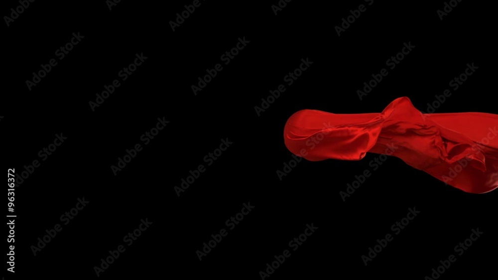 Red fabric flowing in the air on black background shooting with high speed camera, phantom flex.