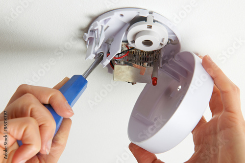 Installing Smoke Detector At Home photo