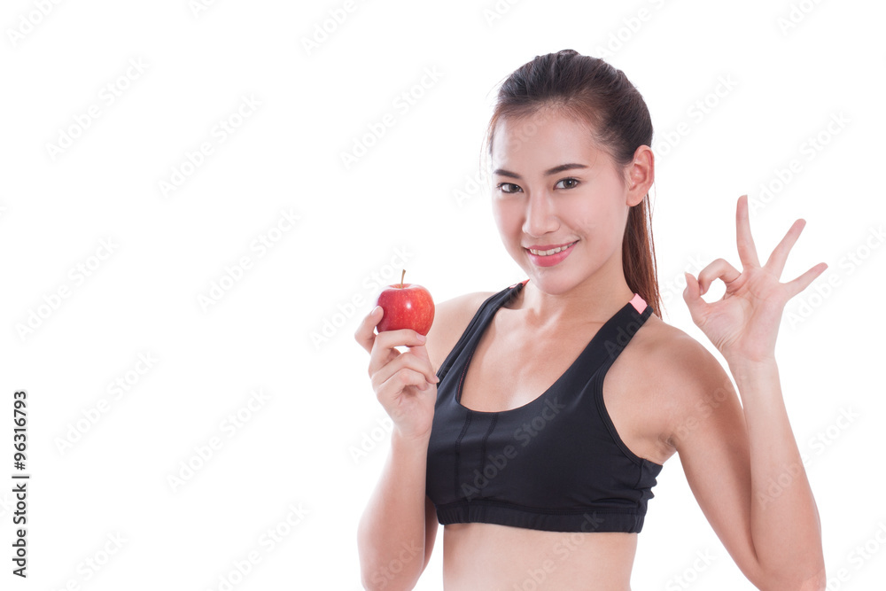 Fitness woman holding apple and showing ok sign Fitness woman holding apple and showing ok sign
