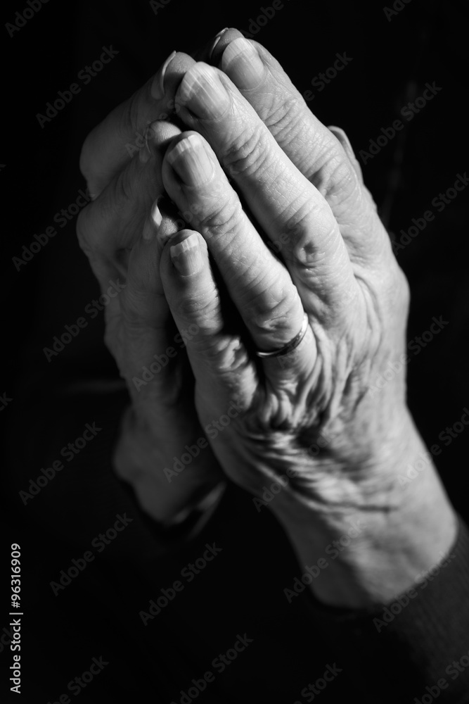 Black & White Image Of Senior Woman's Hands Joined In Prayer