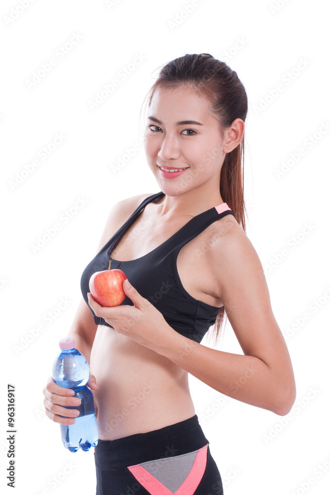 Fitness young woman holding a bottle of water and an apple over white background Fitness young woman holding a bottle of water and an apple over white background