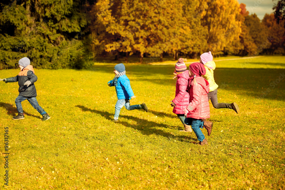 Fototapeta premium group of happy little kids running outdoors