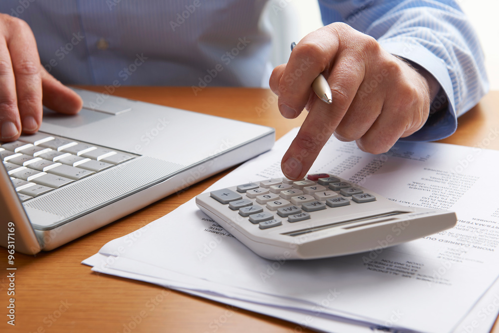 Man Working Out Household Finances Man Working Out Household Finances