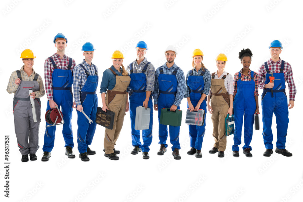 Portrait Of Confident Carpenters Carrying Toolboxes